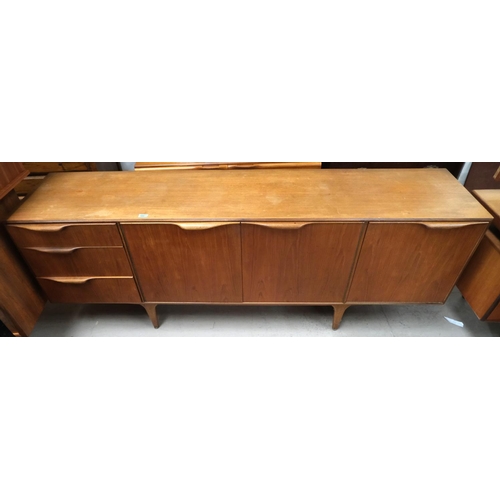 889 - A mid 20th century long low Mcintosh Dunvegan teak sideboard with three drawers, two central cupboar... 