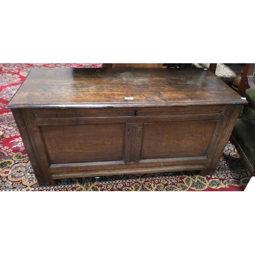 910 - An 18th Century framed and panelled oak blanket box with hinged lid and block feet, width 117 cm.