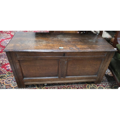 910 - An 18th Century framed and panelled oak blanket box with hinged lid and block feet, width 117 cm.