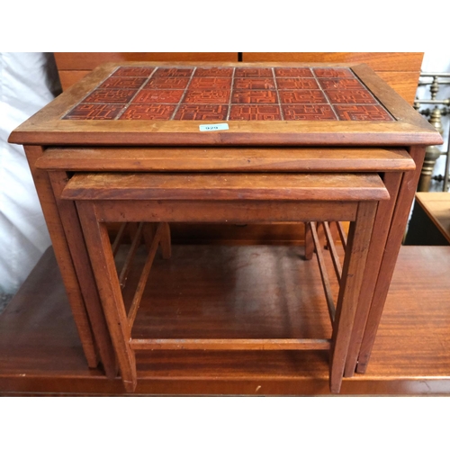 929 - A mid 20th Century Danish teak tile top nest of three tables with geometric patterns.