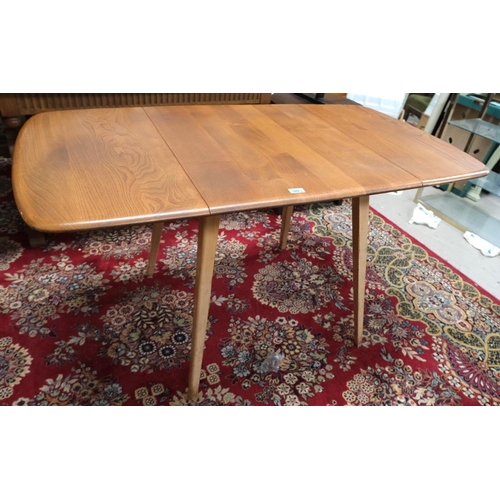 942 - A 1960's rectangular Ercol elm drop-leaf dining table, model 383