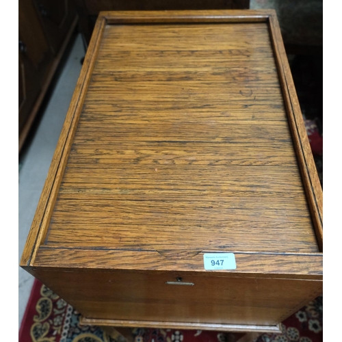 947 - A 1930's golden oak office filing cabinet with tambour top labelled 