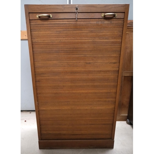 962 - A medium oak office cabinet enclosed by tambour roll front.