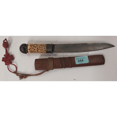 244 - A far Eastern steel dagger with pierced bone handle and carved wood rat finial.