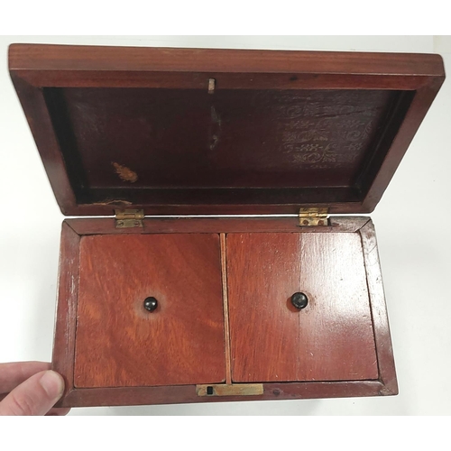 26 - A Georgian mahogany dome top tea caddy on bun feet with two interior compartments.