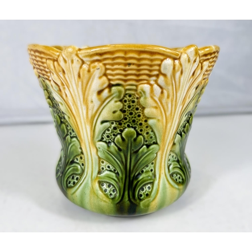 534 - Ault Art Pottery: A circular waisted jardiniere with relief decoration of stylized leaves under a sh... 