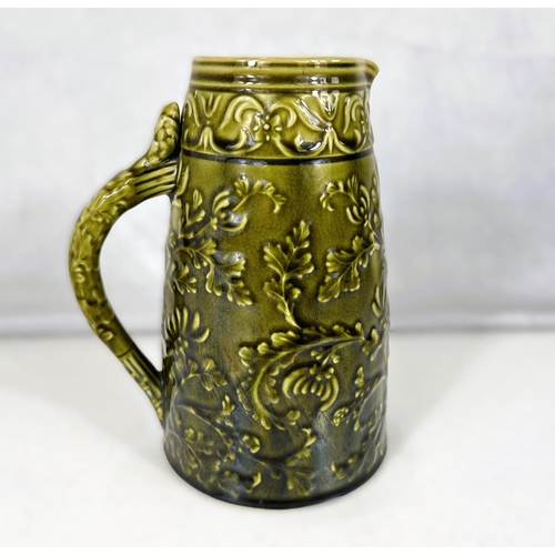 538 - Linthorpe Art Pottery: A jug of tapering cylindrical form with relief decoration of ferns and leaves... 