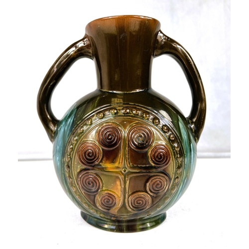 552 - Linthorpe Art Pottery: A flattened circular two handled vase designed by Christopher Dresser, with c...
