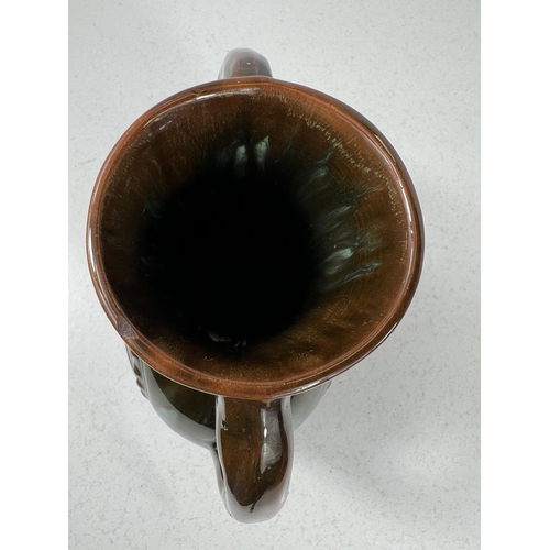 552 - Linthorpe Art Pottery: A flattened circular two handled vase designed by Christopher Dresser, with c... 