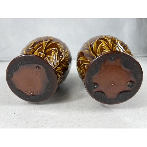 554 - Lindthorpe Art Pottery: - A pair of ovoid vases with wide folded rim, decorated in relief with thist... 