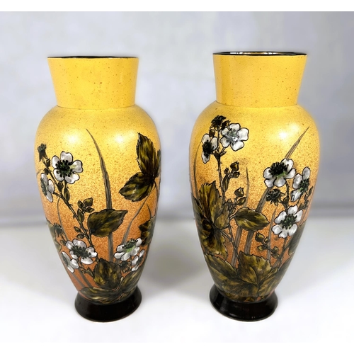 555 - Linthorpe Art Pottery: - A pair of ovoid vases, hand painted with bramble flowers and branches again... 