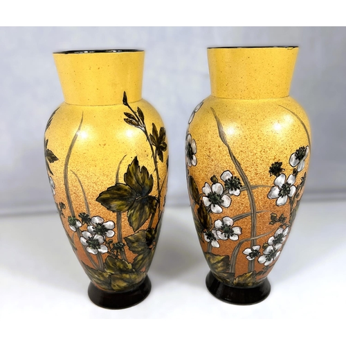 555 - Linthorpe Art Pottery: - A pair of ovoid vases, hand painted with bramble flowers and branches again... 
