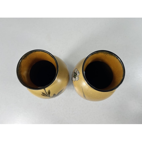 555 - Linthorpe Art Pottery: - A pair of ovoid vases, hand painted with bramble flowers and branches again... 