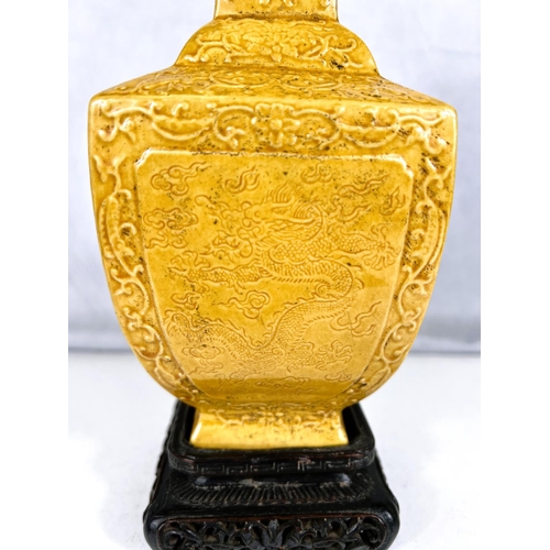 576D - A Chinese yellow glazed vase squared baluster form with relief scrolling decoration including bats e... 