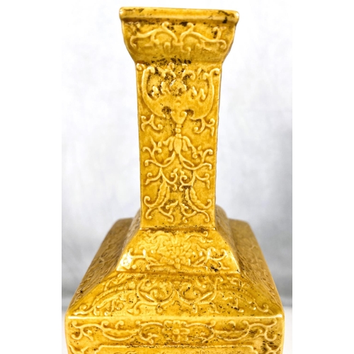 576D - A Chinese yellow glazed vase squared baluster form with relief scrolling decoration including bats e... 