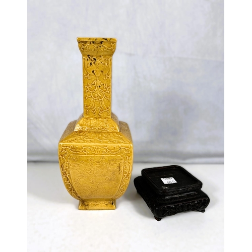 576D - A Chinese yellow glazed vase squared baluster form with relief scrolling decoration including bats e... 