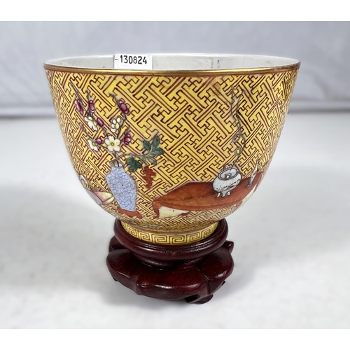 576A - A Chinese yellow ground porcelain cup on stand with red zig-zag pattern with polychrome areas of hig... 