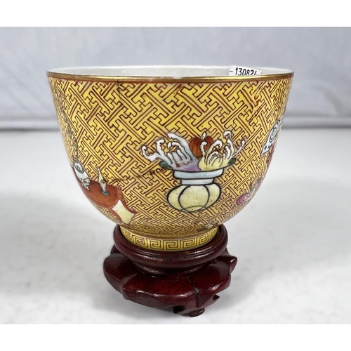 576A - A Chinese yellow ground porcelain cup on stand with red zig-zag pattern with polychrome areas of hig... 