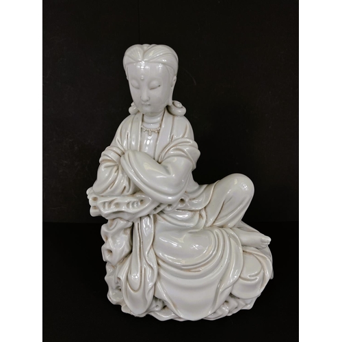 577 - A Chinese blanc de chine figure of Guanyin seated on cloud formation, height 23cm impressed mark to ... 