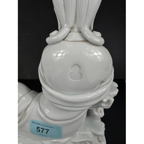 577 - A Chinese blanc de chine figure of Guanyin seated on cloud formation, height 23cm impressed mark to ... 