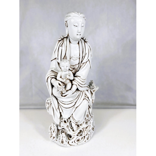 578B - A large Chinese blanc de chine figure of Guanyin with child on clouds with scrolls, bearing impresse... 