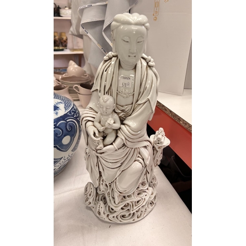 578B - A large Chinese blanc de chine figure of Guanyin with child on clouds with scrolls, bearing impresse... 