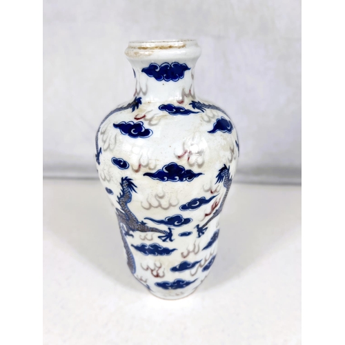 579 - A Chinese blue and white vase with red highlights, dragons flying in clouds, wasted vase, dragon pic... 