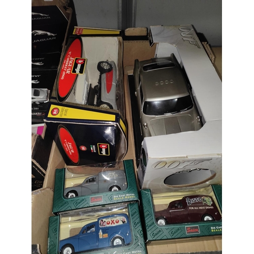 307 - A boxed Burago 1/18th scale Jaguar E Cabriolet, three Saico boxed diecast advertising vans and a 007... 