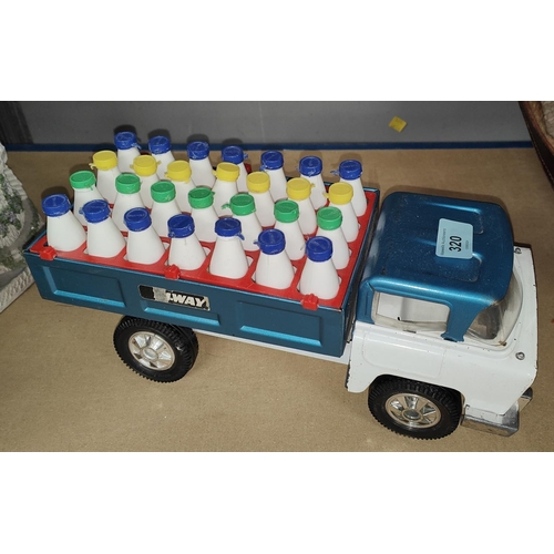 320 - A vintage American Tri-ang milk truck with plastic milk bottles