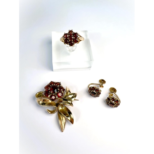 597 - A suite of garnet set 9carat hallmarked gold jewellery including brooch in the form of a flower; two... 