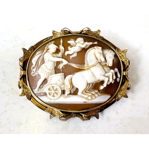 599 - A large oval 19th Century cameo depicting a classical scene with chariot and cherub with trumpet in ... 