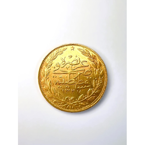 600 - A Middle Eastern gold coin with Arabic script, tests as 18carat plus, 7grams.