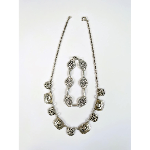 601 - A white metal Scandinavian necklace with alternating links of long boats and Celtic knots; a white m... 