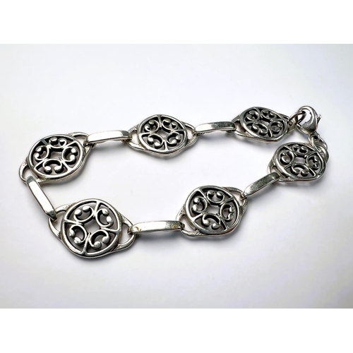 601 - A white metal Scandinavian necklace with alternating links of long boats and Celtic knots; a white m... 