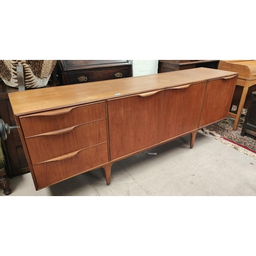 889 - A mid 20th century long low Mcintosh Dunvegan teak sideboard with three drawers, two central cupboar... 