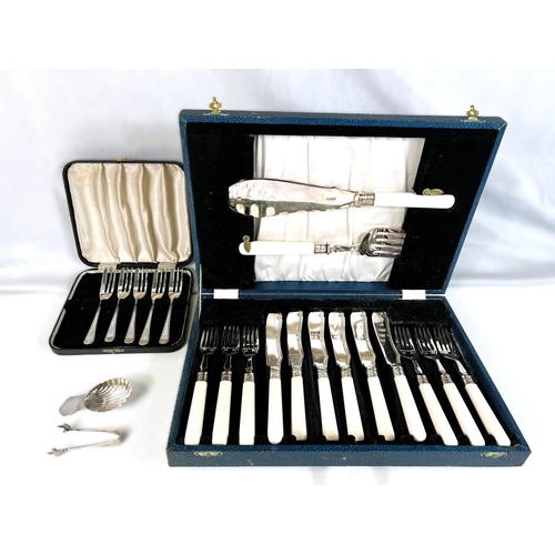 614 - A Silver scallop shaped caddy spoon, Sheffield 1973, five silver cake forks, a pair of tongs  3.5oz ... 