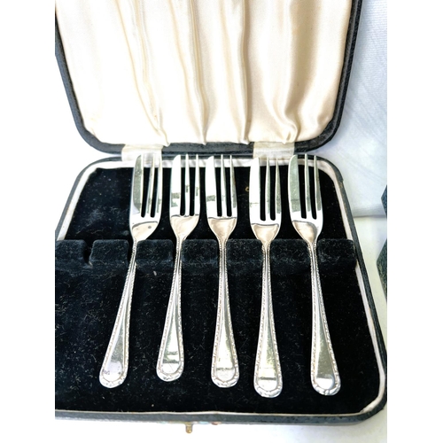 614 - A Silver scallop shaped caddy spoon, Sheffield 1973, five silver cake forks, a pair of tongs  3.5oz ... 