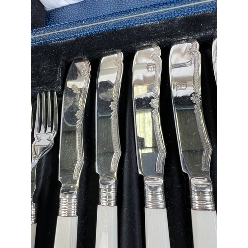 614 - A Silver scallop shaped caddy spoon, Sheffield 1973, five silver cake forks, a pair of tongs  3.5oz ... 