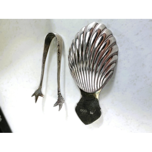 614 - A Silver scallop shaped caddy spoon, Sheffield 1973, five silver cake forks, a pair of tongs  3.5oz ... 