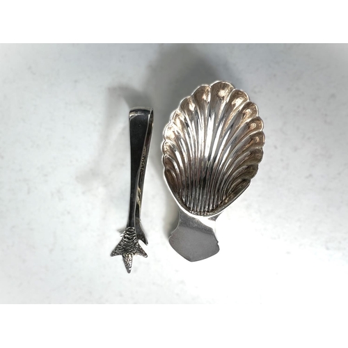 614 - A Silver scallop shaped caddy spoon, Sheffield 1973, five silver cake forks, a pair of tongs  3.5oz ... 