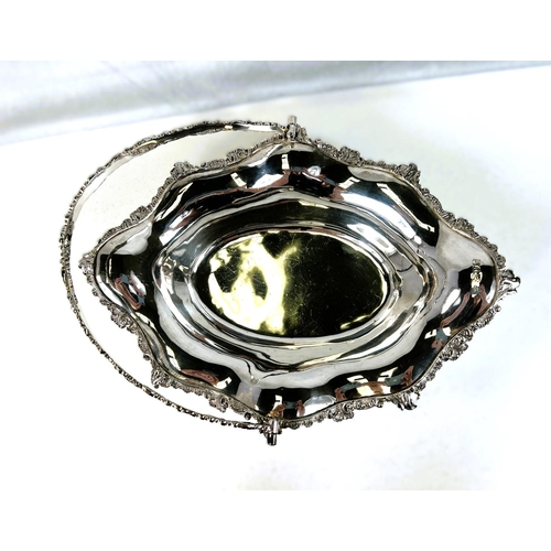 622 - A silver Victorian style sloped oval fruit dish with swag handle, cast scrollwork borders, 4 pierced... 