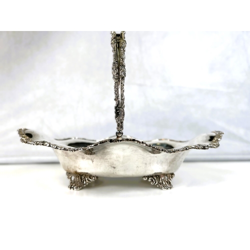 622 - A silver Victorian style sloped oval fruit dish with swag handle, cast scrollwork borders, 4 pierced... 