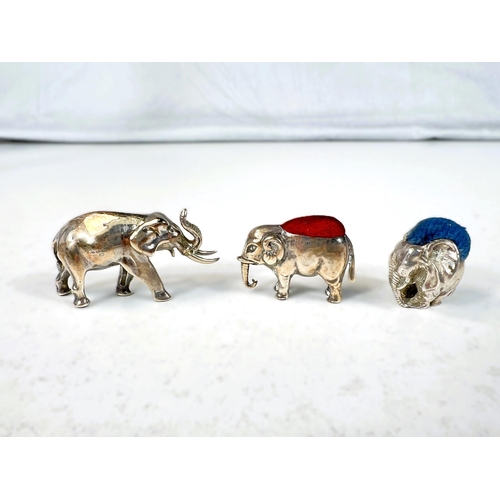 626 - Two miniature novelty hallmarked silver elephant pin cushions and a similar elephant.