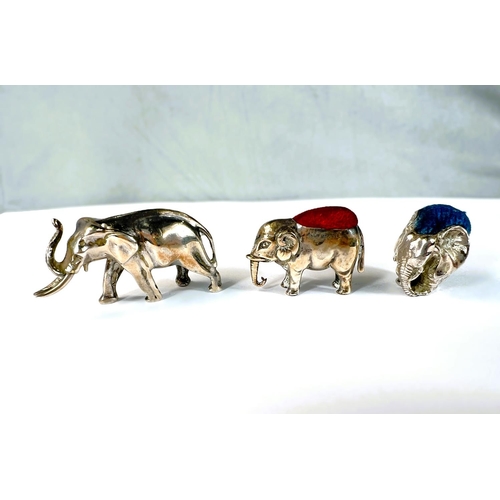 626 - Two miniature novelty hallmarked silver elephant pin cushions and a similar elephant.