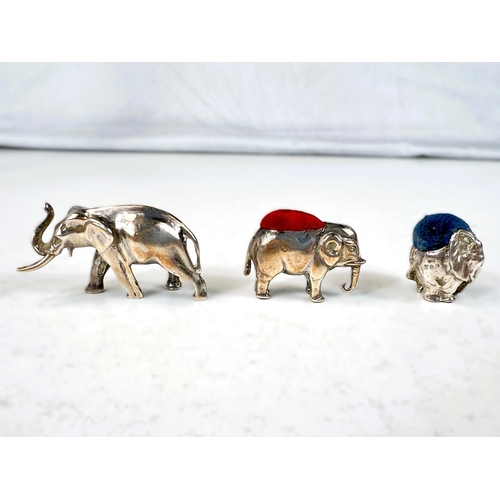 626 - Two miniature novelty hallmarked silver elephant pin cushions and a similar elephant.