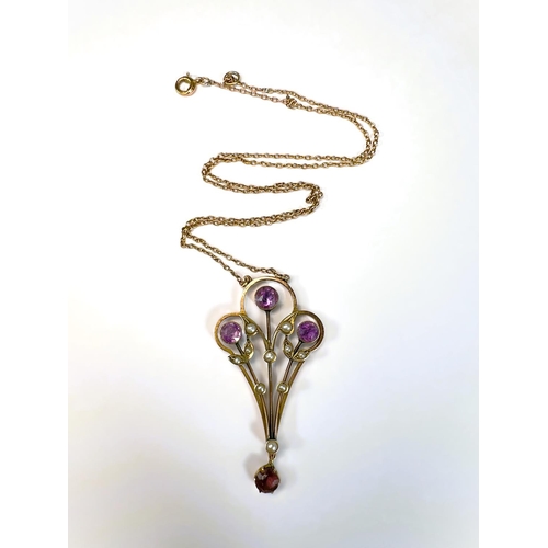 629 - An Edwardian 9ct gold pendant set with amethysts and seed pearls on fine chain stamped