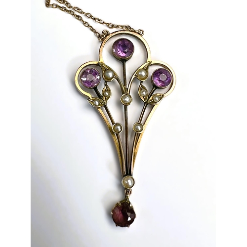 629 - An Edwardian 9ct gold pendant set with amethysts and seed pearls on fine chain stamped