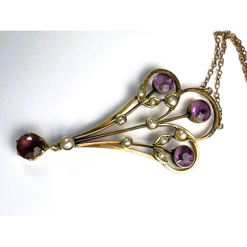 629 - An Edwardian 9ct gold pendant set with amethysts and seed pearls on fine chain stamped