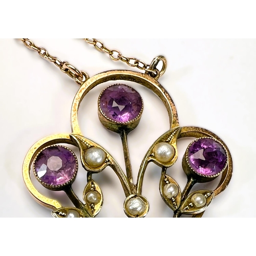 629 - An Edwardian 9ct gold pendant set with amethysts and seed pearls on fine chain stamped