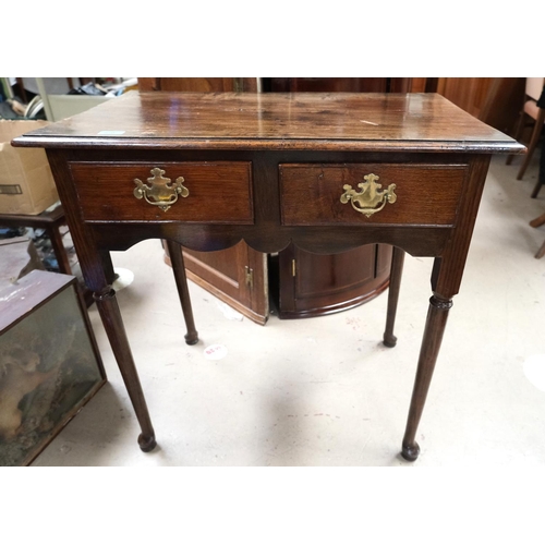 850 - A 19th Century oak low boy with two drawers, brass handles, turned legs on pad feet.